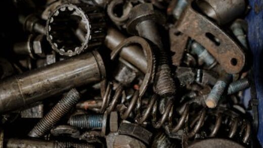 A detailed close-up of various metal gears and spare parts, perfect for industrial themes.